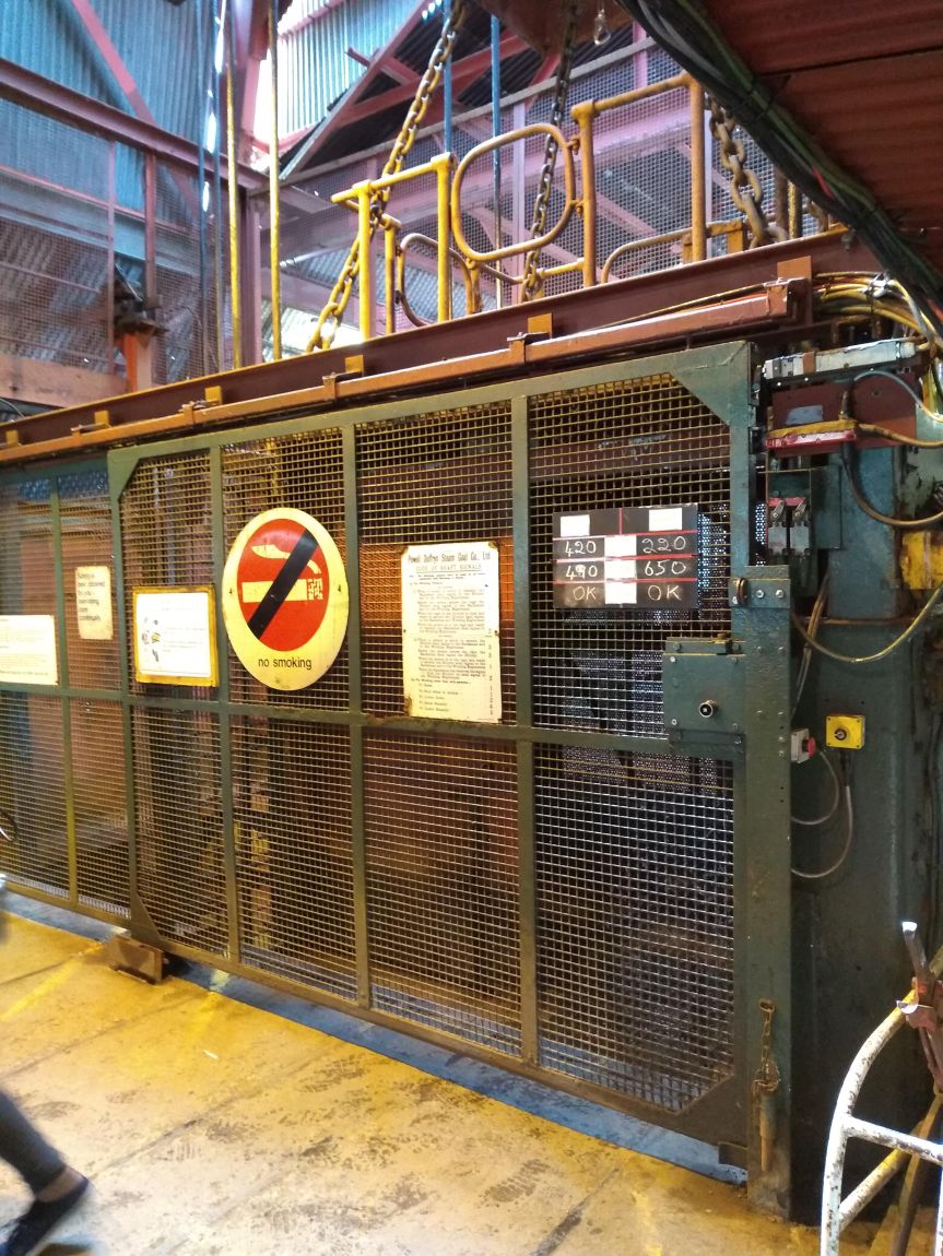 Mining elevator with a large No Smoking sign on it.