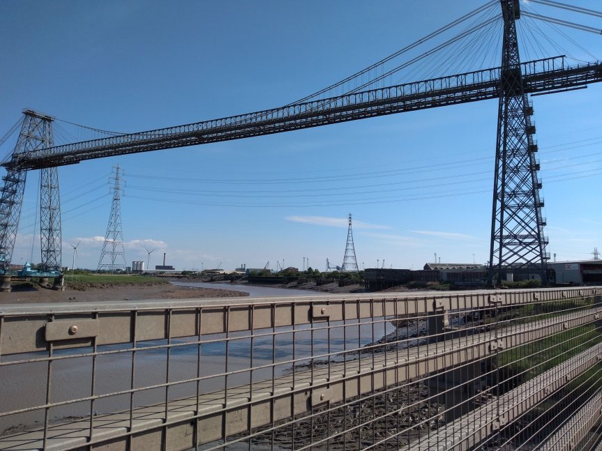 Steel towers with a catwalk suspended by cables high above.